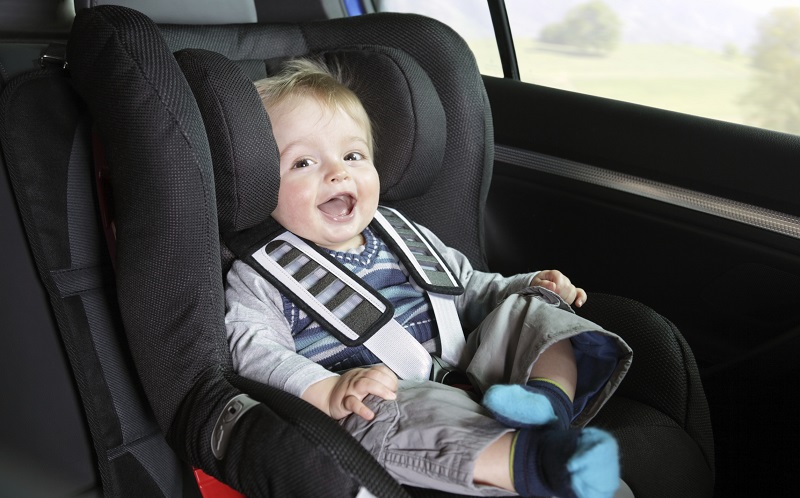 Baby boy in a child safety car seat